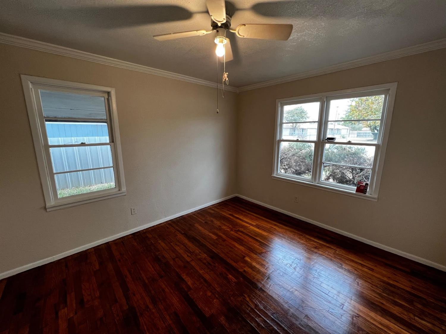 6503 Avenue T Lubbock, TX 79412 - Photo 9 of 15 a view of an empty room with wooden floor and a window