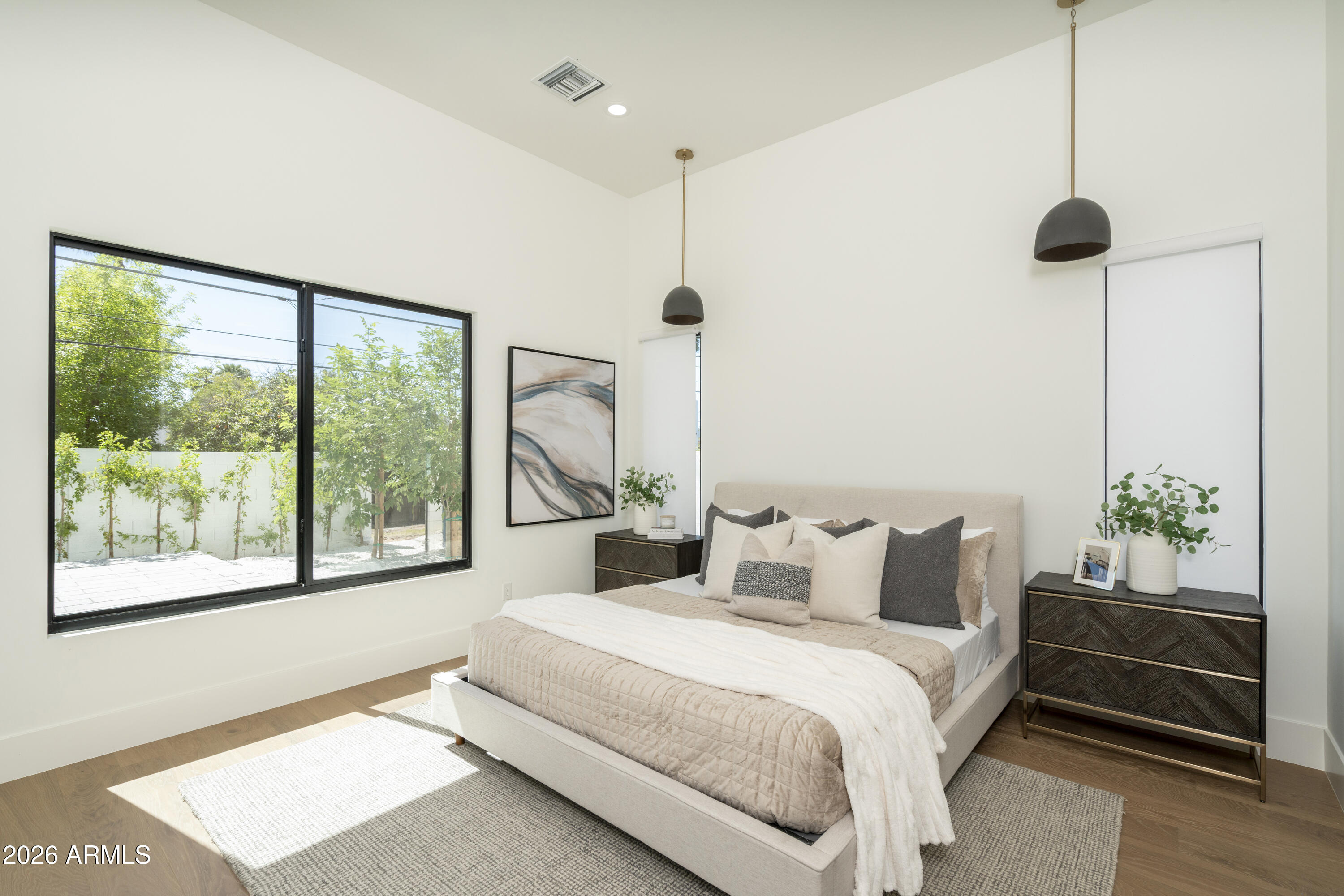 3923 East Heatherbrae Drive Phoenix, AZ 85018 - Photo 22 of 58 a bedroom with a large bed and a large window