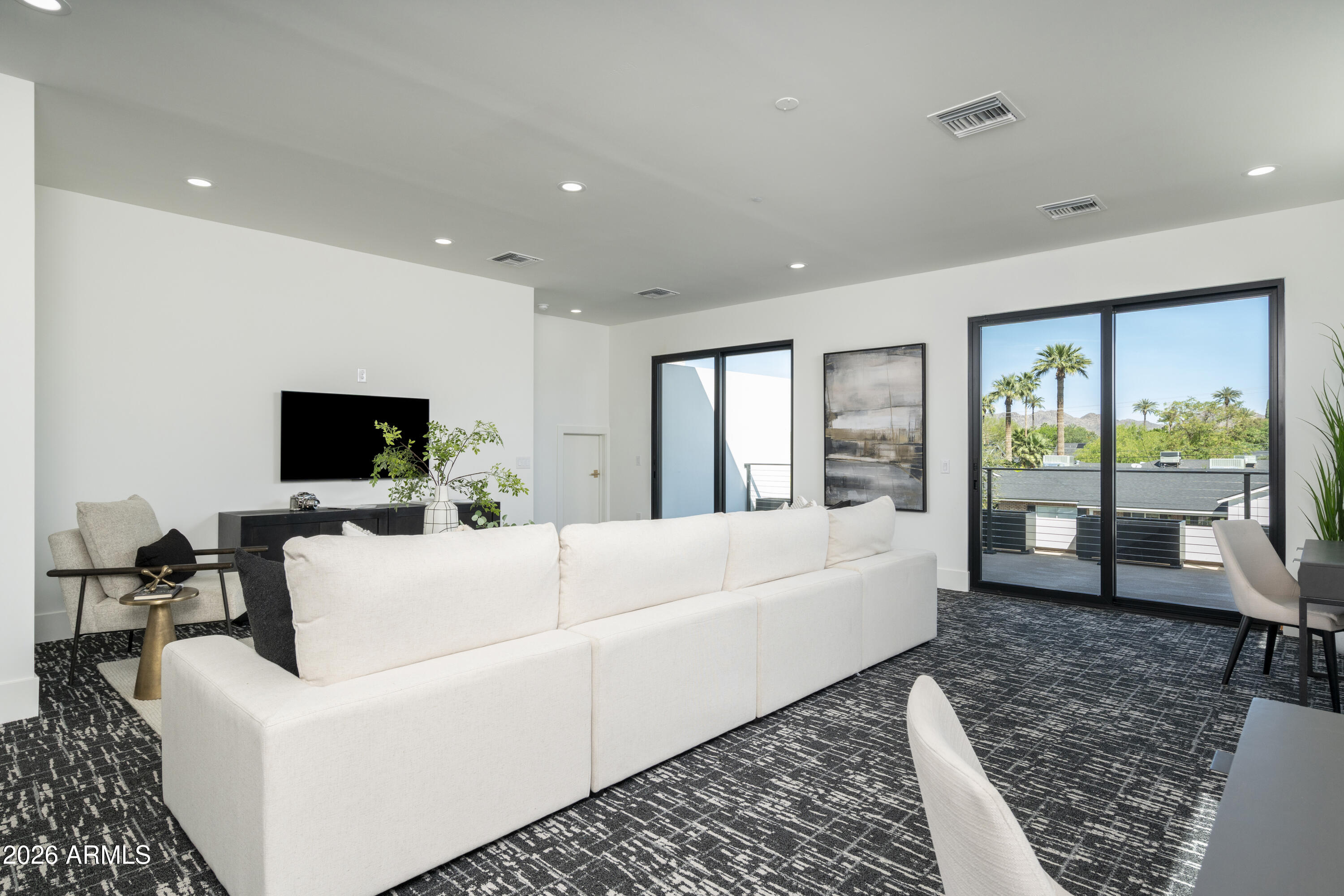3923 East Heatherbrae Drive Phoenix, AZ 85018 - Photo 34 of 58 a living room with furniture and a flat screen tv