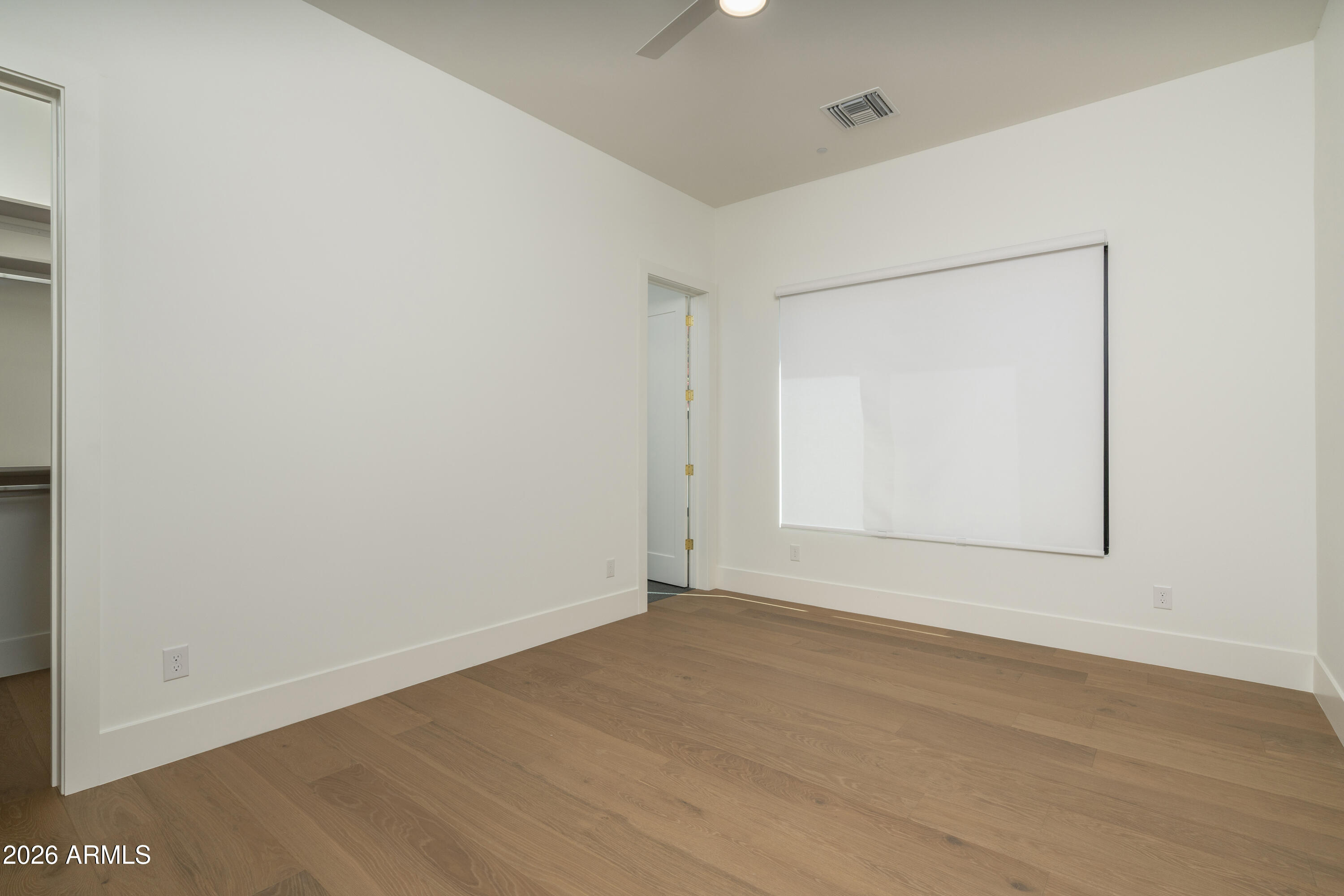 3923 East Heatherbrae Drive Phoenix, AZ 85018 - Photo 45 of 58 a view of an empty room with wooden floor and a window