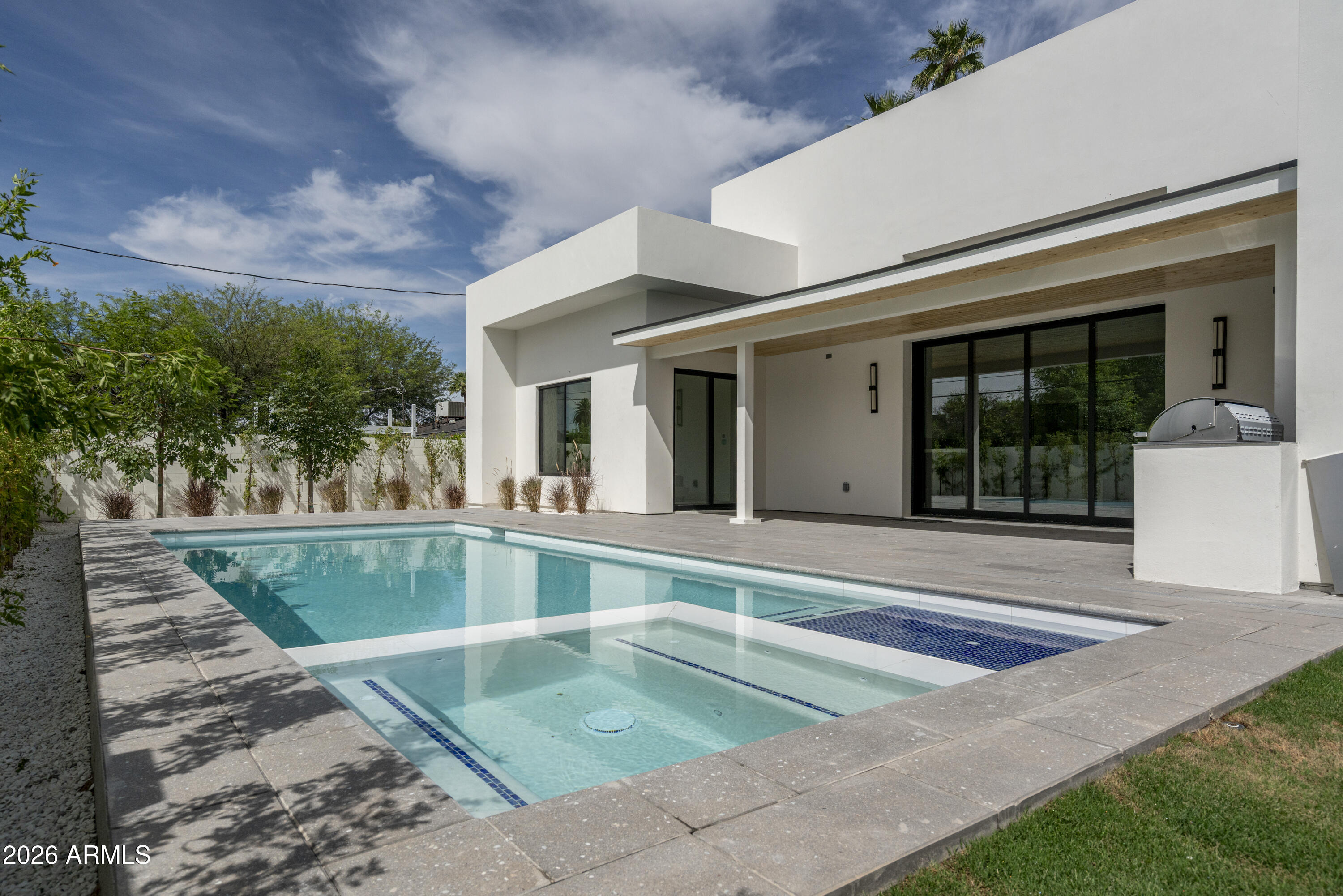 3923 East Heatherbrae Drive Phoenix, AZ 85018 - Photo 55 of 58 a view of a white building with swimming pool in front of it