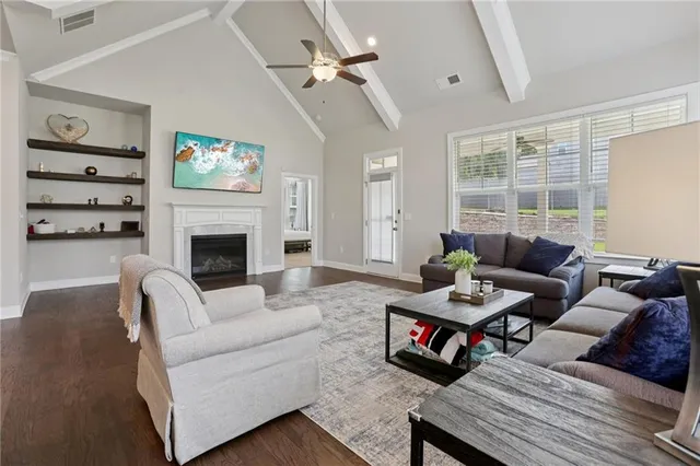 a living room with hard wood floors and a fireplace