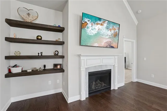 a kitchen with stainless steel appliances granite countertop a sink a stove and a wooden floors