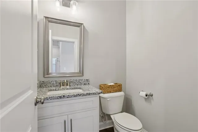 a bedroom with a bed a couch and a chandelier