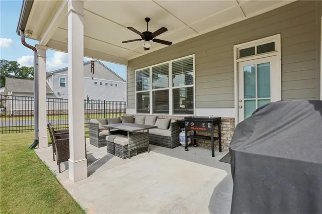 a view of a house with backyard sitting area and garden
