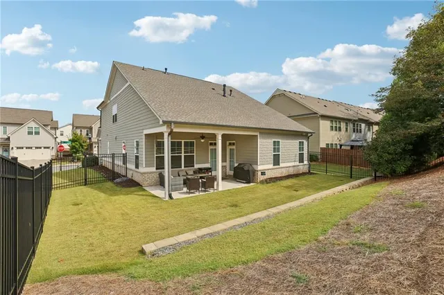 a view of a house with pool and chairs
