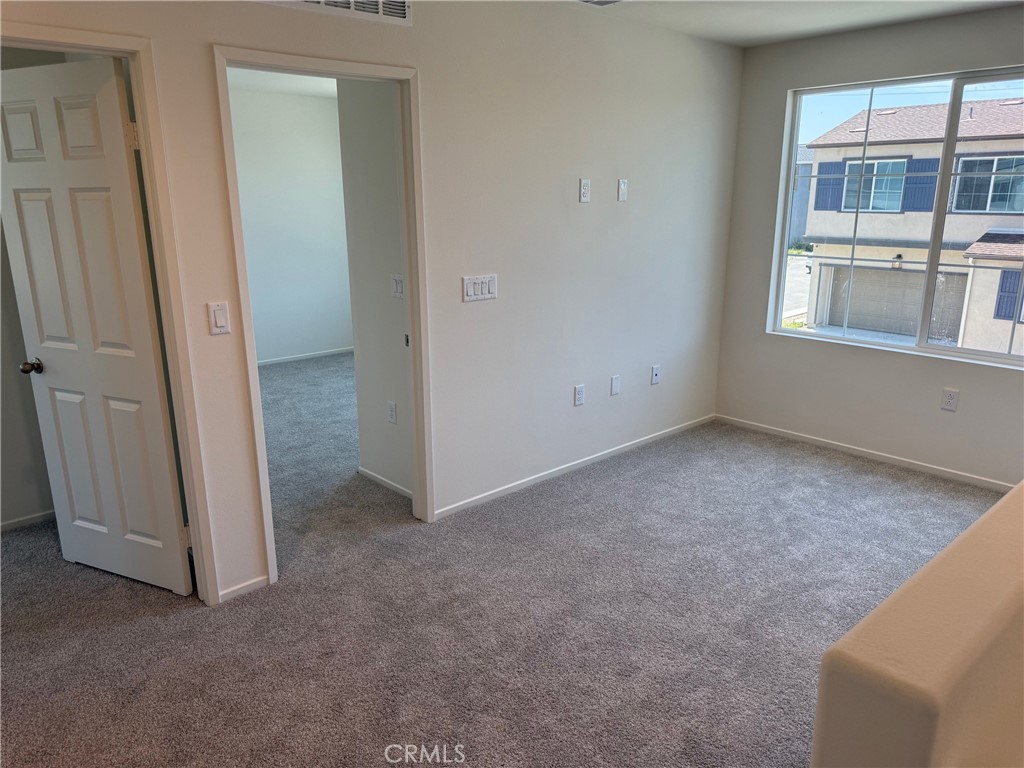 2246 Springmeadow Court Highland, CA 92346 - Photo 4 of 6 an empty room with windows