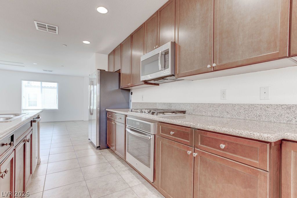 4650 Ranch House Road, Unit 47 North Las Vegas, NV 89031 - Photo 12 of 43 Culinary aspirations find their home in this well-appointed kitchen featuring granite counters and modern appliances.