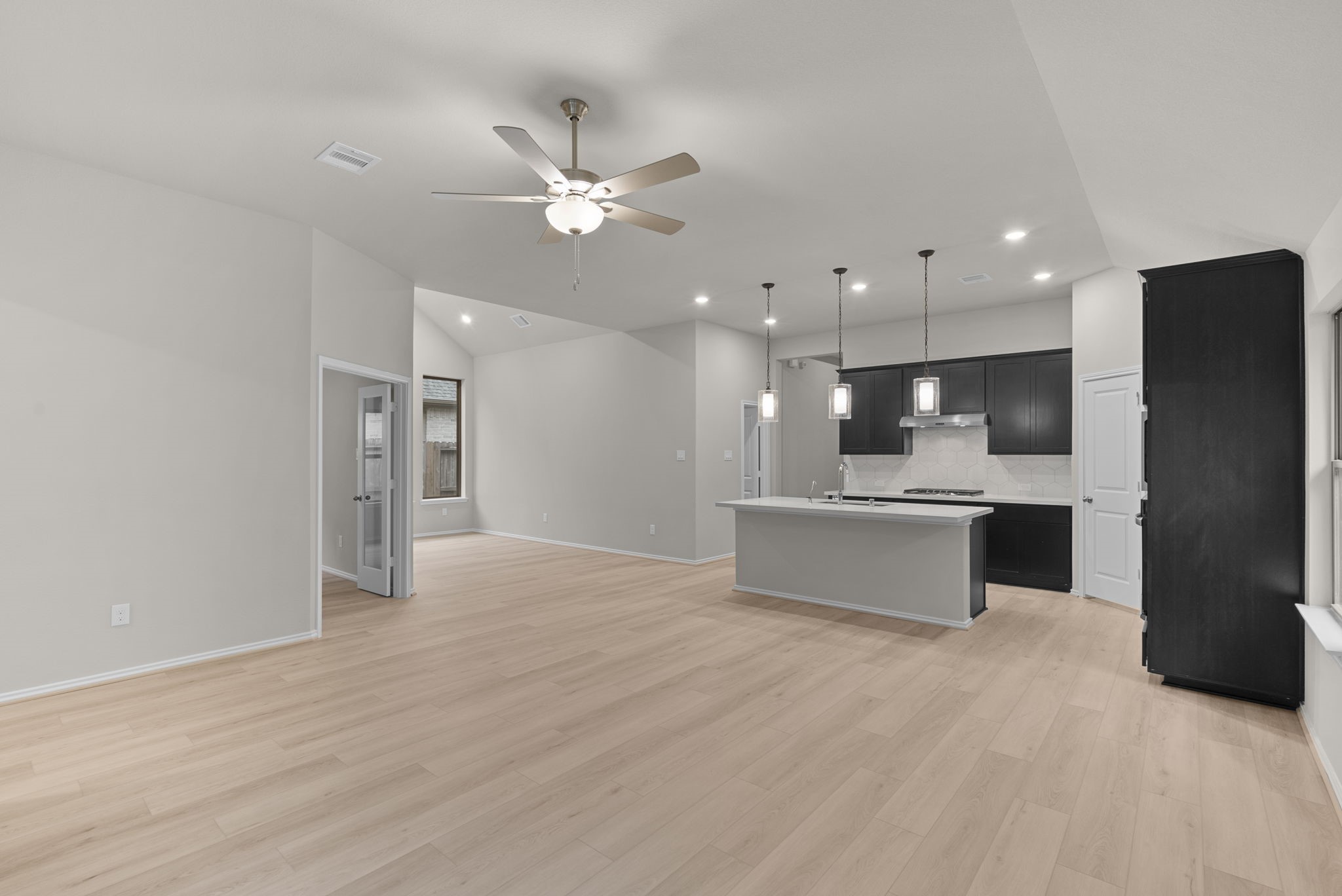 9628 Mount Brewer Lane Porter, TX 77365 - Photo 7 of 36 a large kitchen with a refrigerator and a chandelier