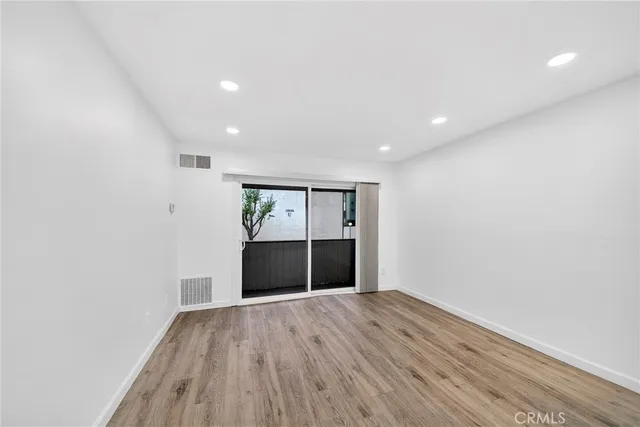 a view of room with wooden floor