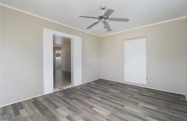 a view of empty room with wooden floor