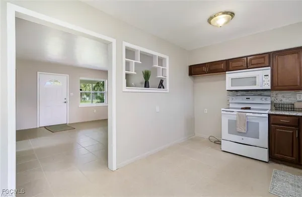 a view of a kitchen with electric appliances