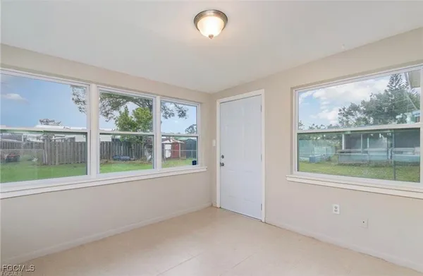 an empty room with wooden floor and a window