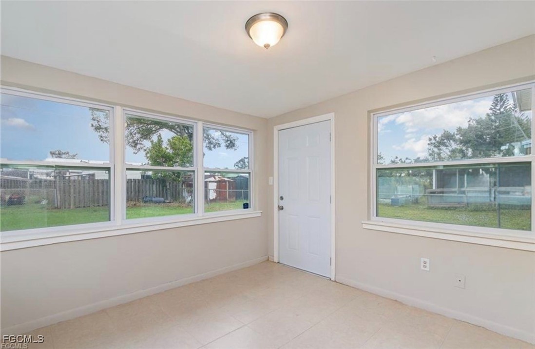 12937 Fourth Street Fort Myers, FL 33905 - Photo 10 of 26 an empty room with wooden floor and a window