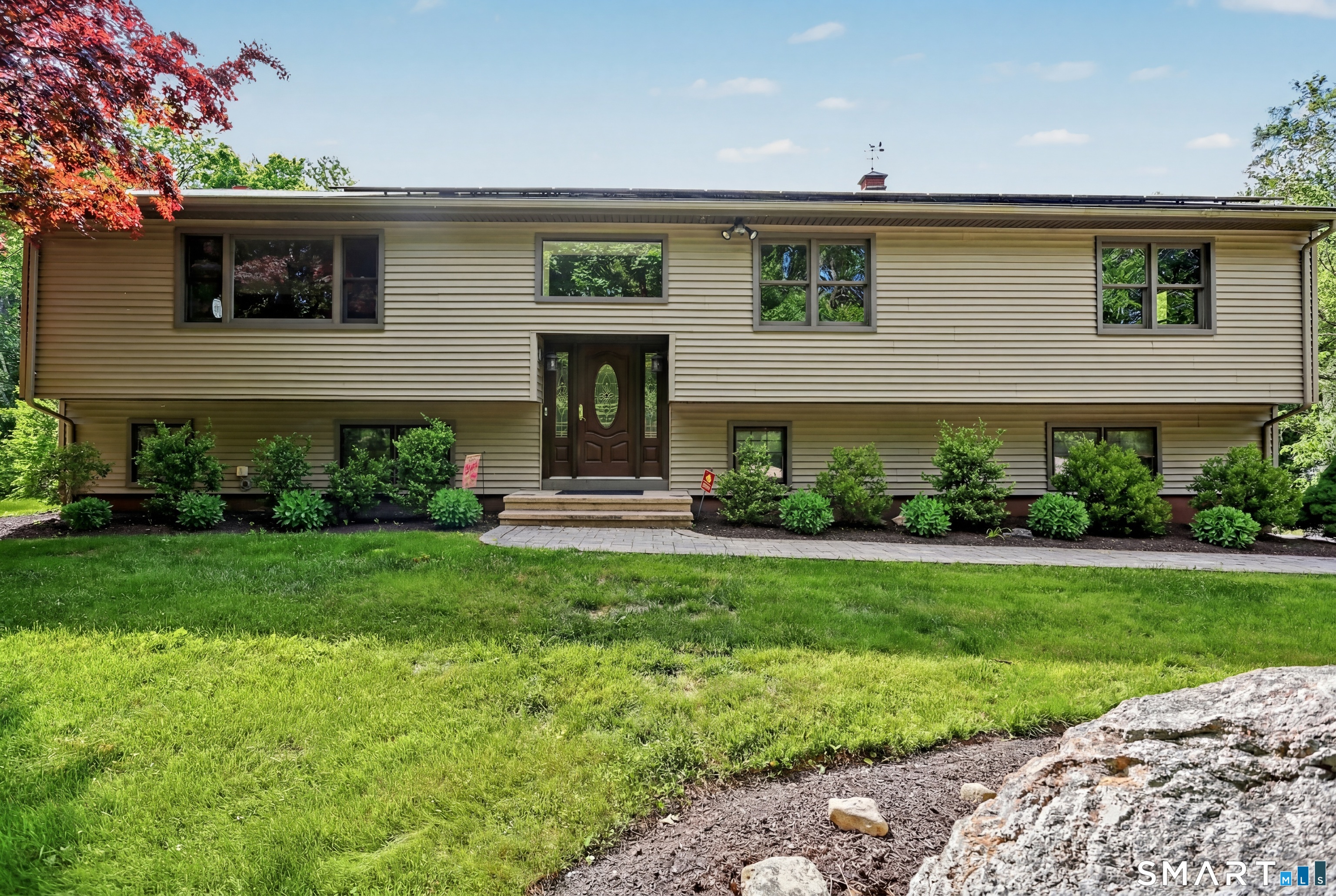 632 Wheelers Farm Road Orange, CT 06477 - Photo 1 of 39 a front view of a house with a yard and potted plants
