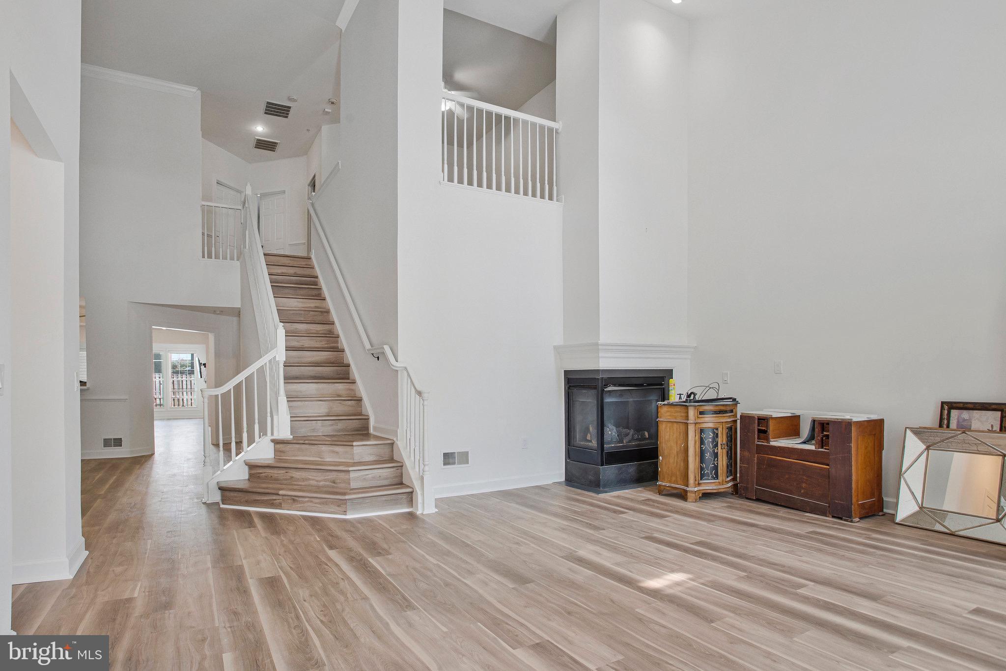 322 Hamlet Circle Edgewater, MD 21037 - Photo 5 of 21 a view of a livingroom with wooden floor and staircase