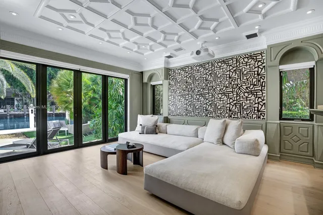 a living room with furniture and a floor to ceiling window