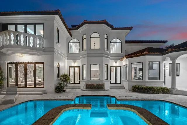 a front view of a house with swimming pool and porch