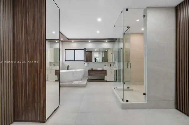a bathroom with a large tub shower and sink