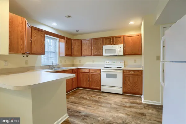a kitchen with a stove a sink and a refrigerator