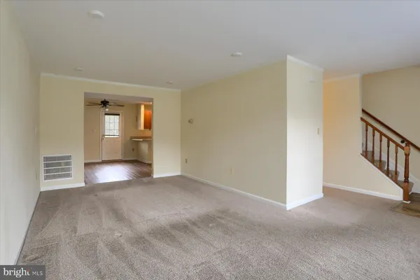 a view of empty room with wooden floor and windows
