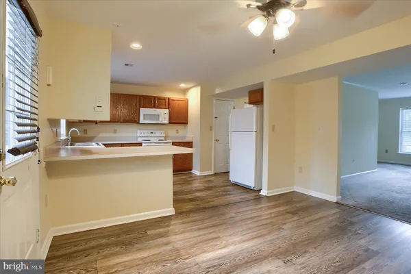 a kitchen with a refrigerator and a stove top oven