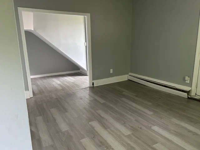 an empty room with wooden floor