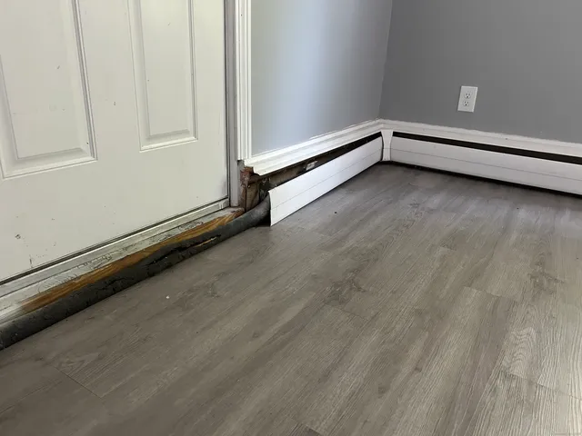 a view of an empty room and wooden floor