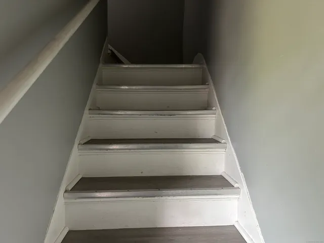 a view of a room with wooden floor