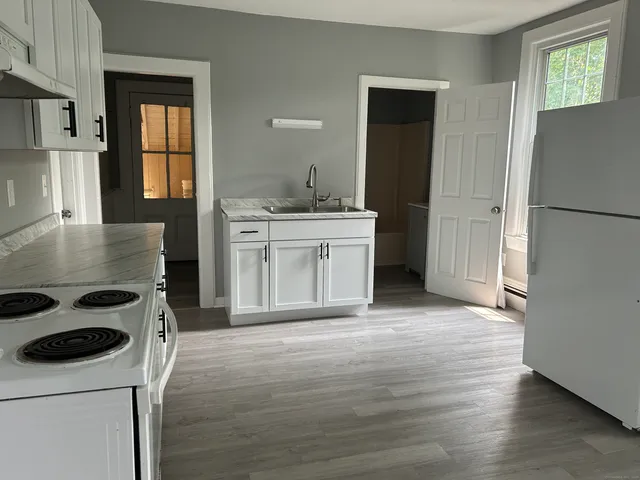 a kitchen with a stove sink and refrigerator