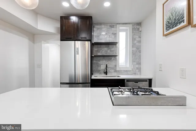a bathroom with a sink a large mirror and a shower