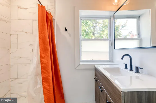 a bathroom with a sink and a window