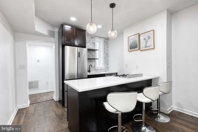 a large kitchen with a table and chairs