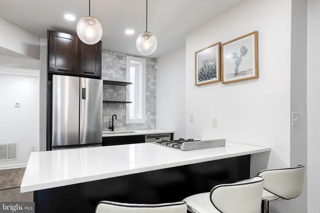 a bathroom with a sink a toilet a mirror and vanity