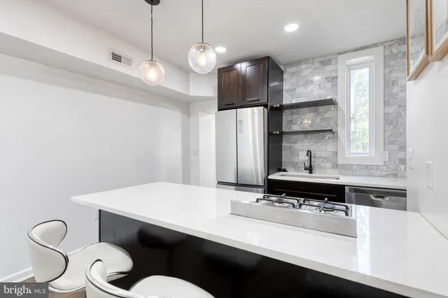 a kitchen with stainless steel appliances a sink and a refrigerator