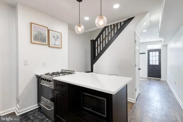 a kitchen that has a stove and a table