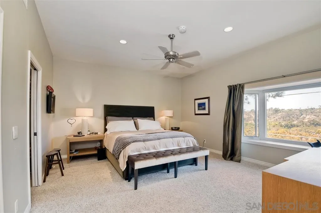 3622 Garner Place Encinitas, CA 92024 - Photo 19 of 25 a spacious bedroom with a bed and a large window