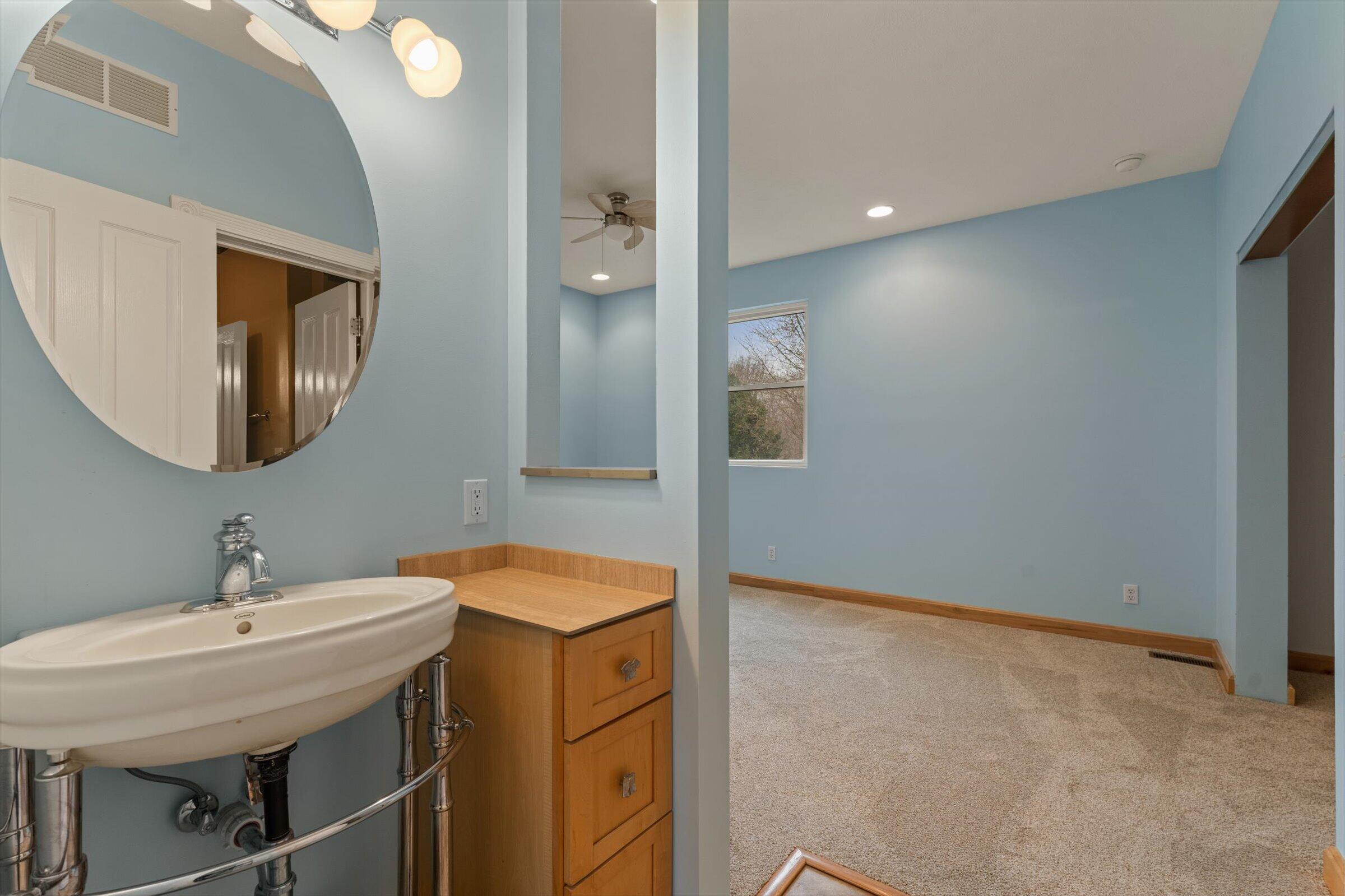 7692 North Emery Road Rolling Prairie, IN 46371 - Photo 33 of 69 a bathroom with a sink and a mirror