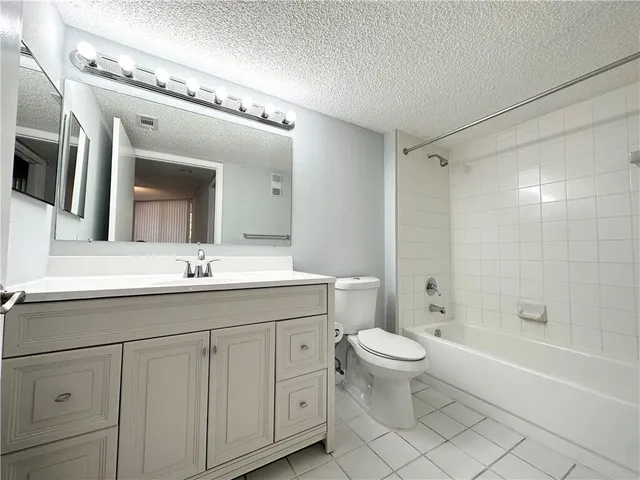 a bathroom with a double vanity sink mirror and toilet