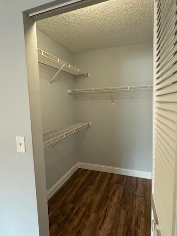 a view of a room with wooden floor and cabinet
