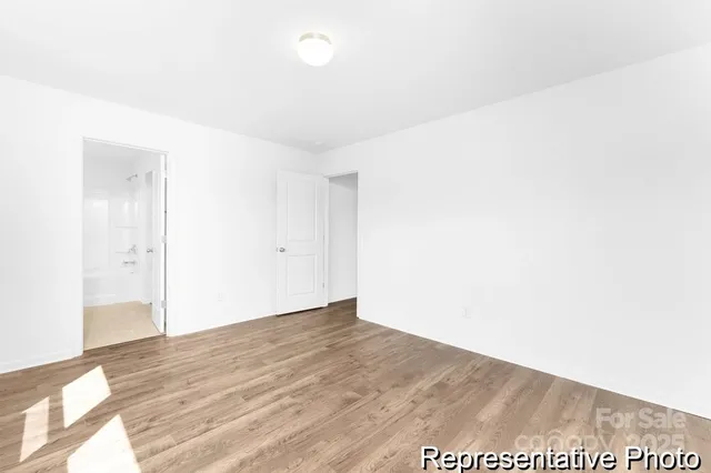 a spacious bathroom with a shower sink and mirror