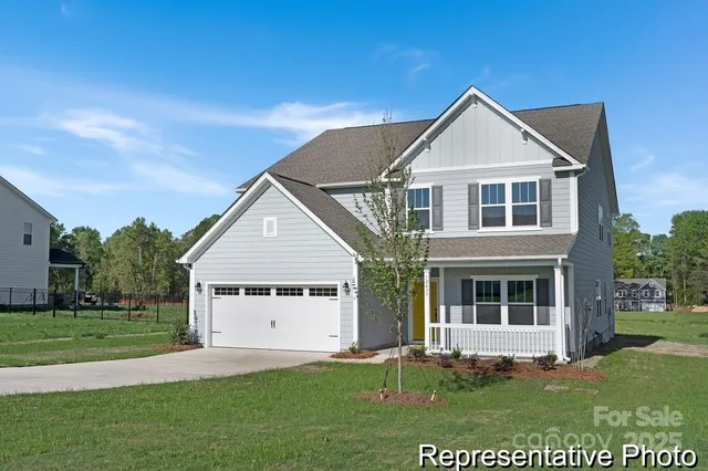 a view of kitchen with granite countertop window and stainless steel appliances