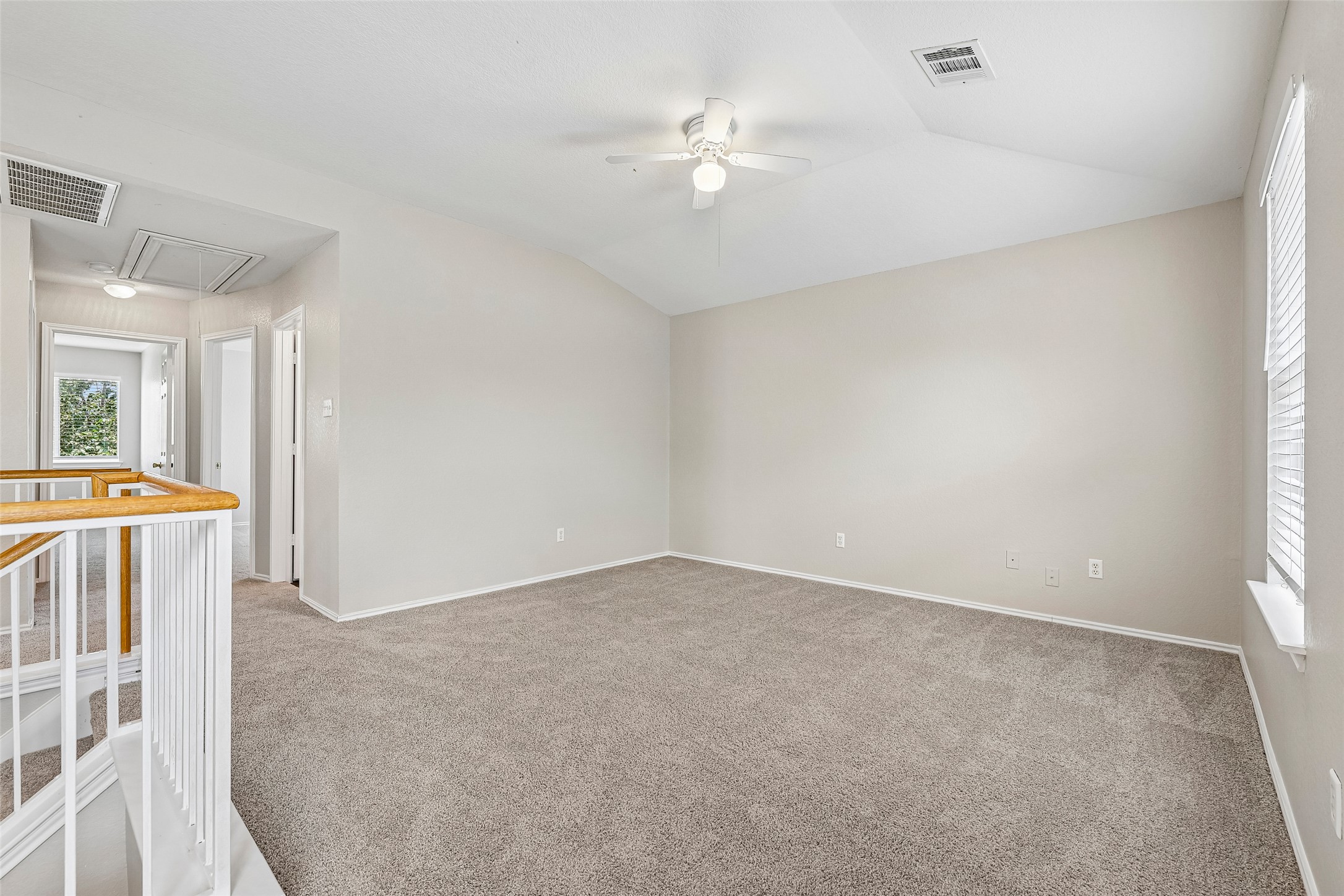 616 Scheel Road Kyle, TX 78640 - Photo 18 of 39 A spacious upper-level area offers plush carpeting and a ceiling fan for comfort.