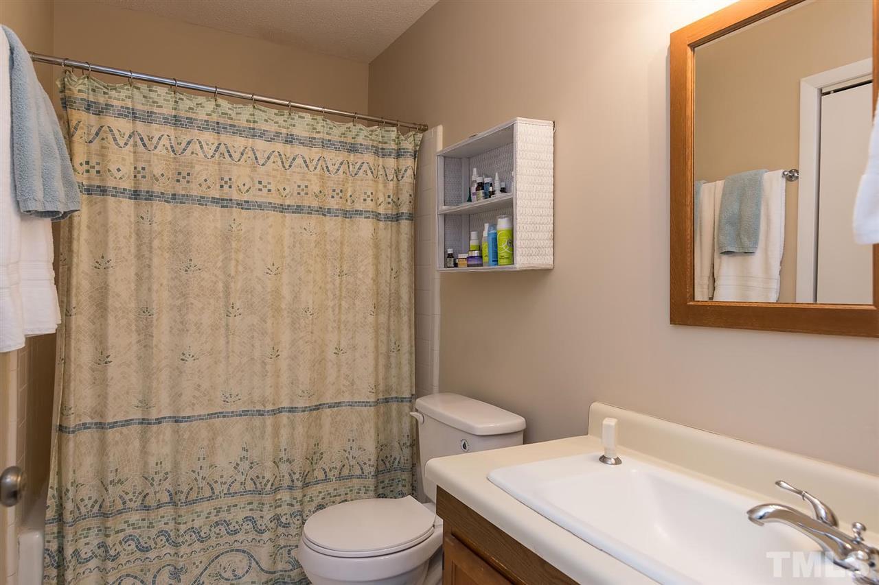 5845 Shady Grove Circle Raleigh, NC 27609 - Photo 11 of 16 a bathroom with a sink a toilet and shower