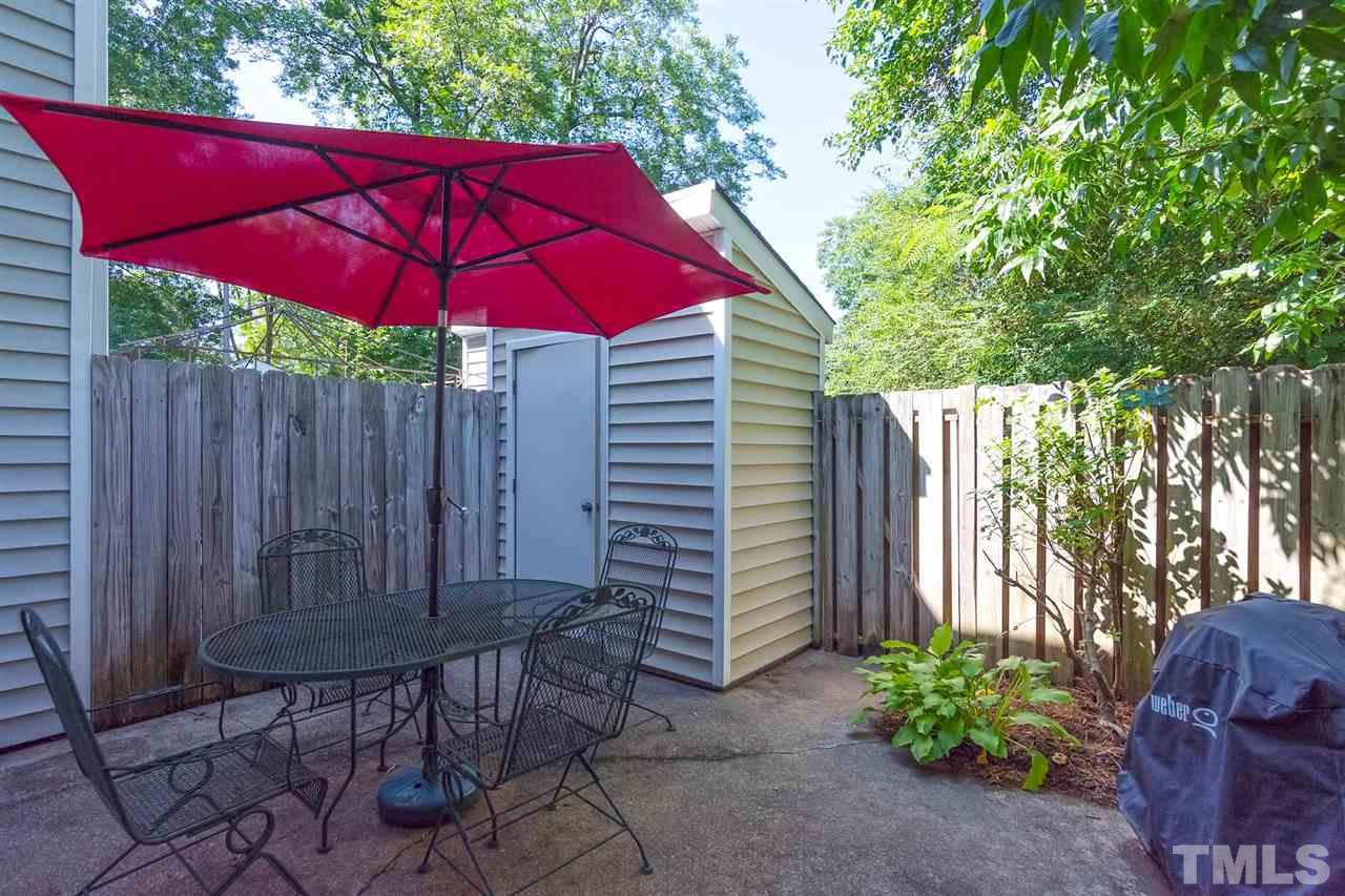 5845 Shady Grove Circle Raleigh, NC 27609 - Photo 14 of 16 a view of a backyard with furniture and a small cabin