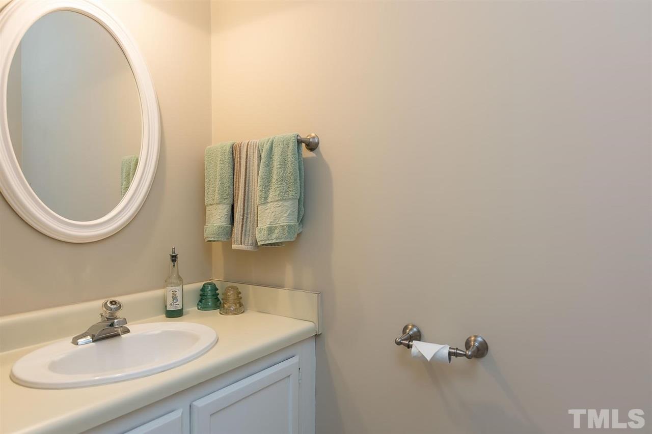 5845 Shady Grove Circle Raleigh, NC 27609 - Photo 5 of 16 a bathroom with a sink and a mirror