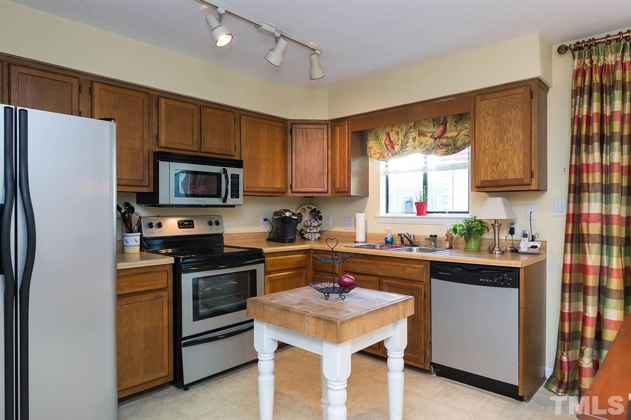 5845 Shady Grove Circle Raleigh, NC 27609 - Photo 6 of 16 a kitchen with a sink a stove a microwave and refrigerator