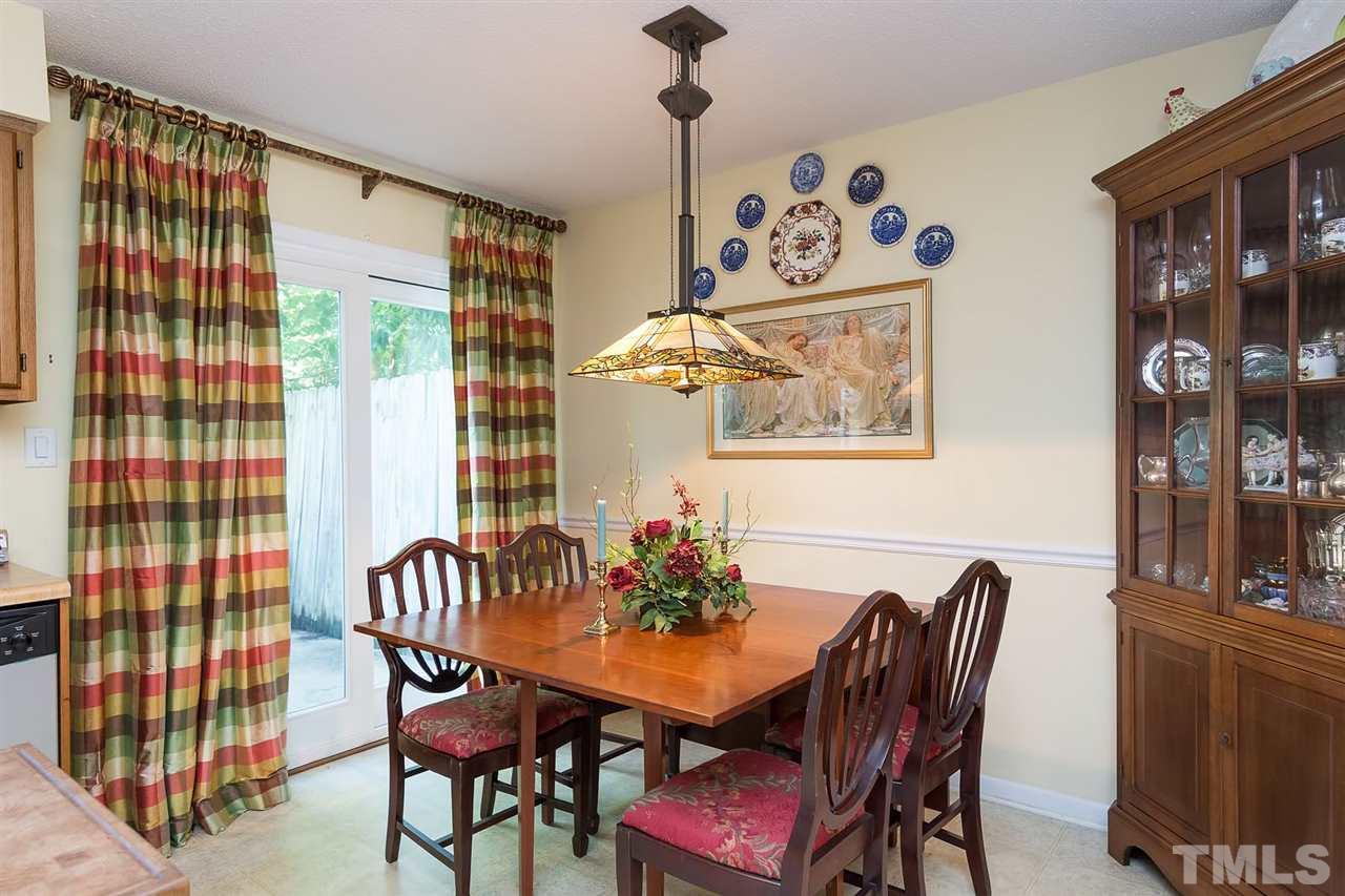 5845 Shady Grove Circle Raleigh, NC 27609 - Photo 8 of 16 a view of a dining room with furniture and chandelier