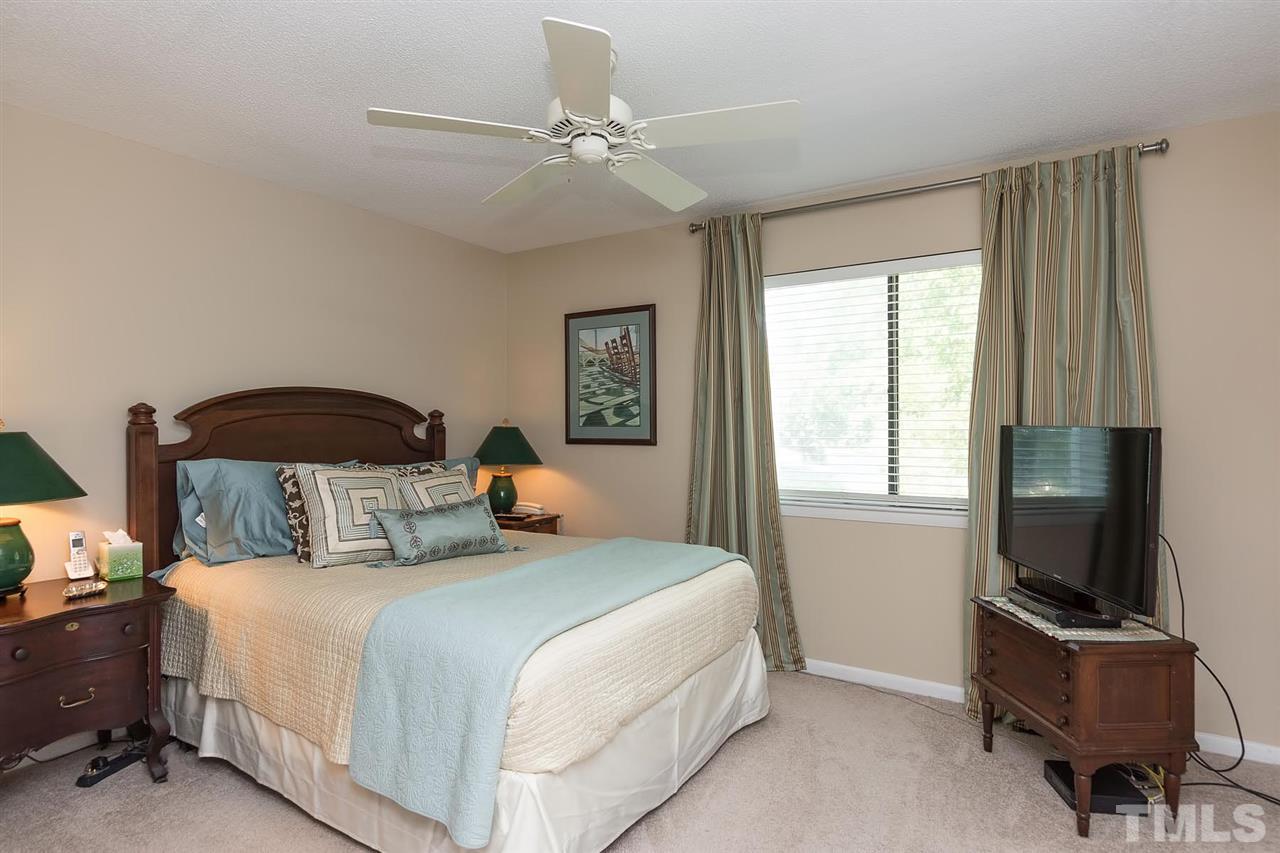 5845 Shady Grove Circle Raleigh, NC 27609 - Photo 9 of 16 a bedroom with a bed and a flat screen tv