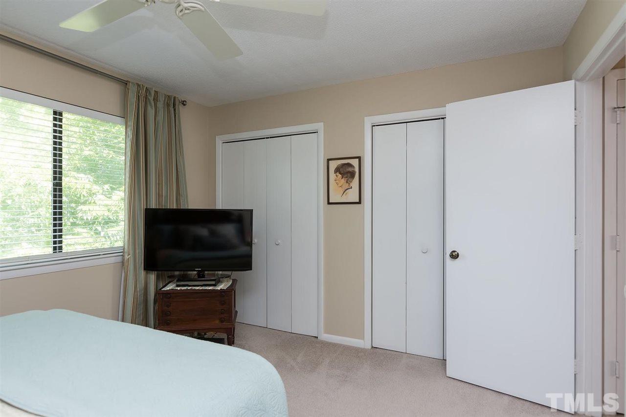 5845 Shady Grove Circle Raleigh, NC 27609 - Photo 10 of 16 a bedroom with a bed and a flat screen tv